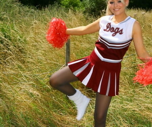 Lovely European cheerleader Tamar poses with respect to black pantyhose with respect to nature