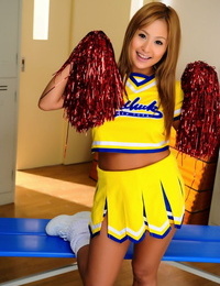 Adorable Japanese cheerleader uncovers great tits before showing her pussy