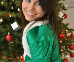 Amateur Xmas elf Hailey lifts her tight skirt to show her sexy ass by the tree