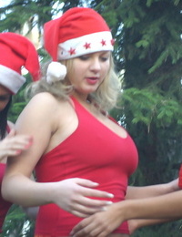 Busty lesbians play with each other nipples while in the woods in Xmas attire