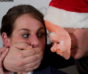 Creepy man in a Santa mask ball gags and ties up a clothed brunette
