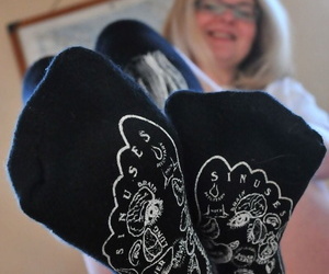 Older tow-haired Tasty Trixie slides pantalettes aside wearing skeleton socks