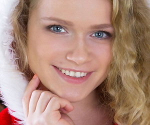 Cute teen girl doffs her Christmas outfit for nude posing over the holidays