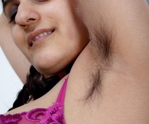 Hirsute brunette Riani uncovers her big natural tits after playing with Lego