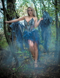 Fairy-haired cosplay lass Nikki Sims doffs her wings and wisp to pose in a strap