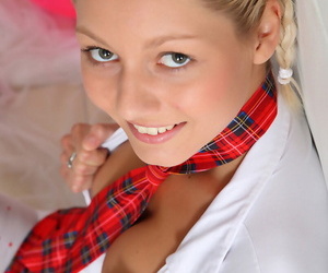 Young blonde Pinky June rides on top of her dildo pillow in a necktie