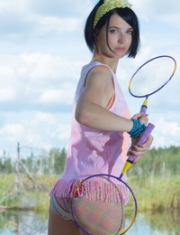 Shady haired youthful doll lays down her badminton rackets and takes her clothes off bare