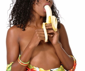 Ebony dime Krystel eats a banana after peeling off her floral print swimsuit