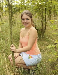 Charming teen with miniature pantoons removes her clothes to finger her puss in the woods