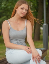 Redhead European babe undressing to bare tiny teen tits during glam shoot