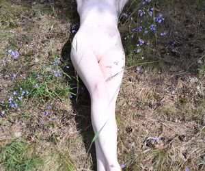 Petite teen Gerda peels off high cut underwear to pose nude near a forest