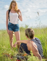 Blonde teenager with firm tits leads her guy into the tall grass to fuck