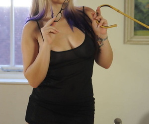 Deputy Headmistress Elise posing in stockings and heels with a cane