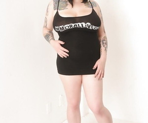 Fatty tattooed brunette Scarlet Lavey shows her nice big boobies