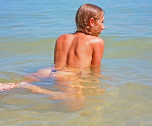 Busty blonde babe Victoria Nelson swimming topless in the sea