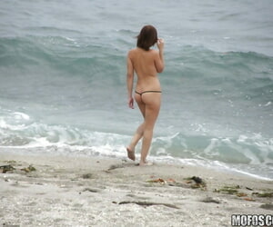 Brunette teen Krystal Banks gets sneak-peaked by a voyeur on the beach