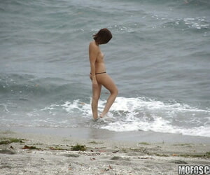 Brunette teen Krystal Banks gets sneak-peaked by a voyeur on the beach