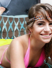 Blonde teen Kimmy Granger modelling solo in bright colored bikini