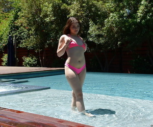 Leggy teen babe Kylie Quinn strips off shorts and bikini outdoors by pool