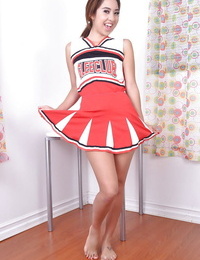 Adolescent Eastern infant Mila Jade exposing mini bumpers below cheerleader outfit
