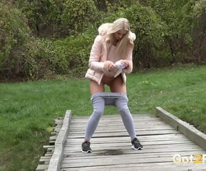 Blonde Katy Sky shows her bald beaver while squatting outside for a pee