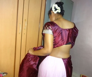 Clothed Indian woman strips to her black bra and underskirt