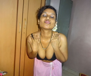 Clothed Indian woman strips to her black bra and underskirt