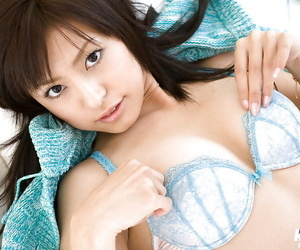 Pretty asian babe Misaki Mori slipping off her lingerie on the bed