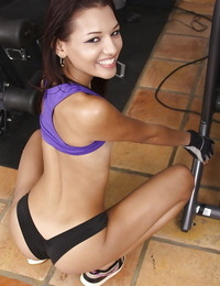 Sporty youthful Cassie Cruz striping and jerking off her vagina in the gym