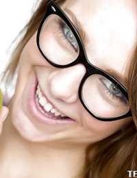 Smiley schoolgirl in glasses with compact body obtains in nature\'s garb in the classroom