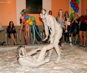 Seductive fetish ladies get involved in fully clothed mud wrestling