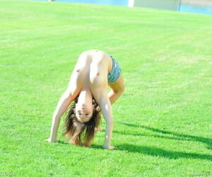 Veelzijdig tiener Voert ga ga gymnastiek in een Park voor gaan blote kont binnenshuis