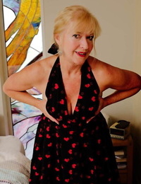 Blonde granny Veronique takes off heels and panties before masturbating