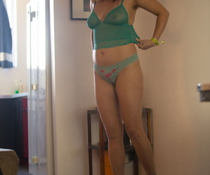 Lifeless feminine in striated socks pulls atop a thong as A she gets dressed