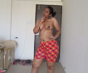 Topless Indian woman begins to pull down her shorts and underwear