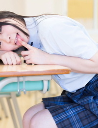 Sexually intrigued Oriental schoolgirl lifts up her short skirt and masturbates