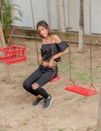 Smiley perspired glamour model Karin Torres looking hawt in ripped jeans on a swing