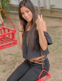Smiley perspired glamour model Karin Torres looking hawt in ripped jeans on a swing