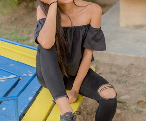 Smiley hot glamour girl Karin Torres looking sexy in ripped jeans on a swing