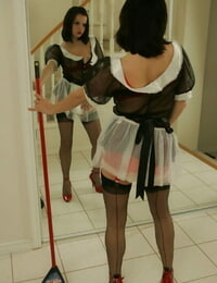 Brunette hottie in nylon stockings taking off her maid uniform