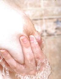 Wet babe flaunting big saggy pornstar tits and nipples in bathtub