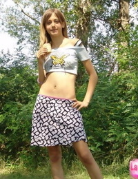 Skinny flat chested young lass teases with abs bare in short petticoat outdoors