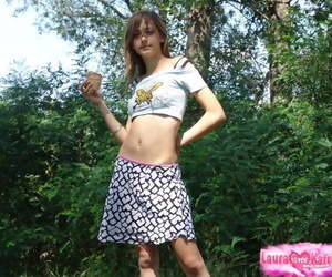 Skinny flat chested young girl teases with abs bare in short skirt outdoors
