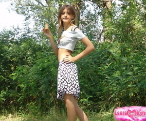 Skinny flat chested young girl teases with abs bare in short skirt outdoors