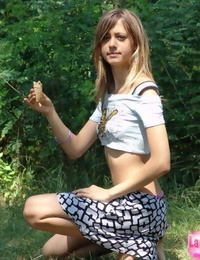 Skinny flat chested young lass teases with abs bare in short petticoat outdoors