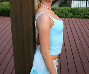 Blonde amateur Skye Model flashes an upskirt butt cheek on the back patio