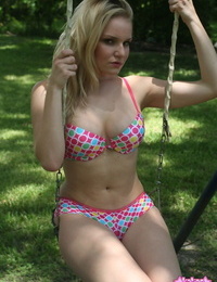 Teen golden-haired cutie launches to take off her bikini dominant on a swingset
