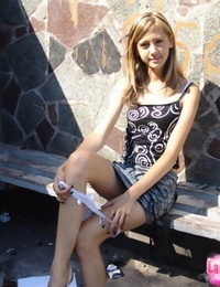 Young skinny girl in short skirt removes her panties to walk in the sunshine