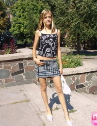 Young skinny girl in short skirt removes her panties to walk in the sunshine