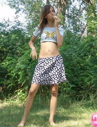 Shapely amateur amateur in insignificant t-shirt and short skirt posing outdoors